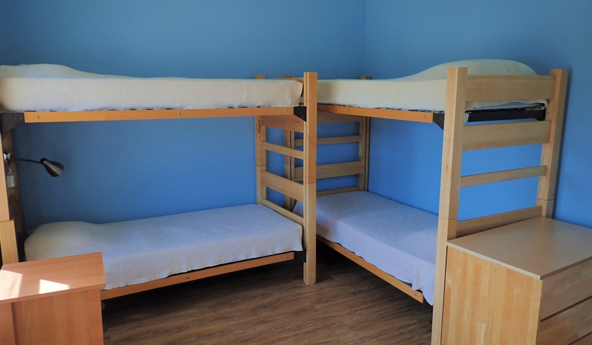 Bedroom 2 sleeps 4 in 2 bunk beds with 2 dressers and a walk-in closet.
