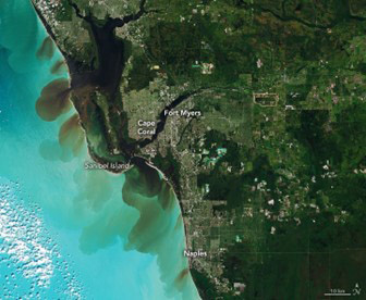 Figure 1. Satellite imagery shows dark water from the tidal passes mixing with the Gulf of Mexico (NOAA).